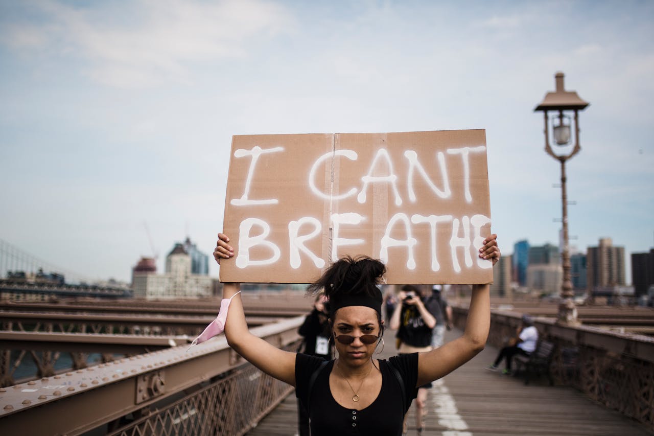 Crafting Captivating Headlines: Your awesome post title goes here A protester holds an 'I Can't Breathe' sign during a demonstration on a bridge.